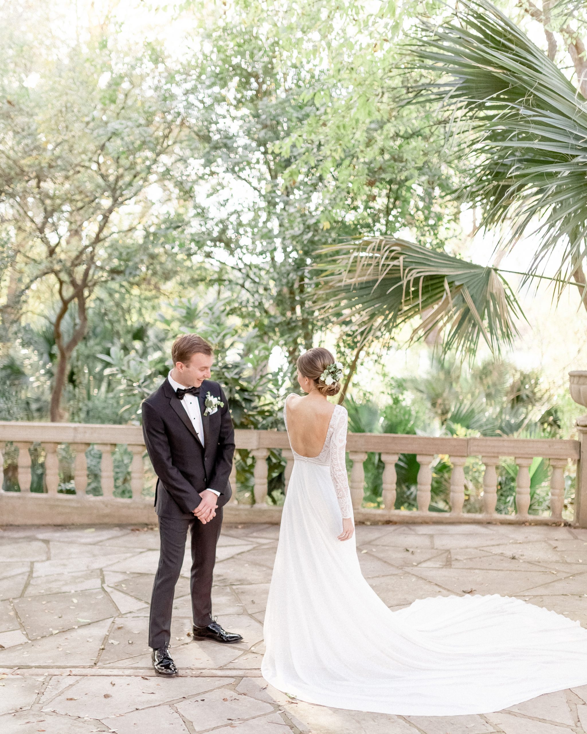 couple doing a first look in a green courtyard