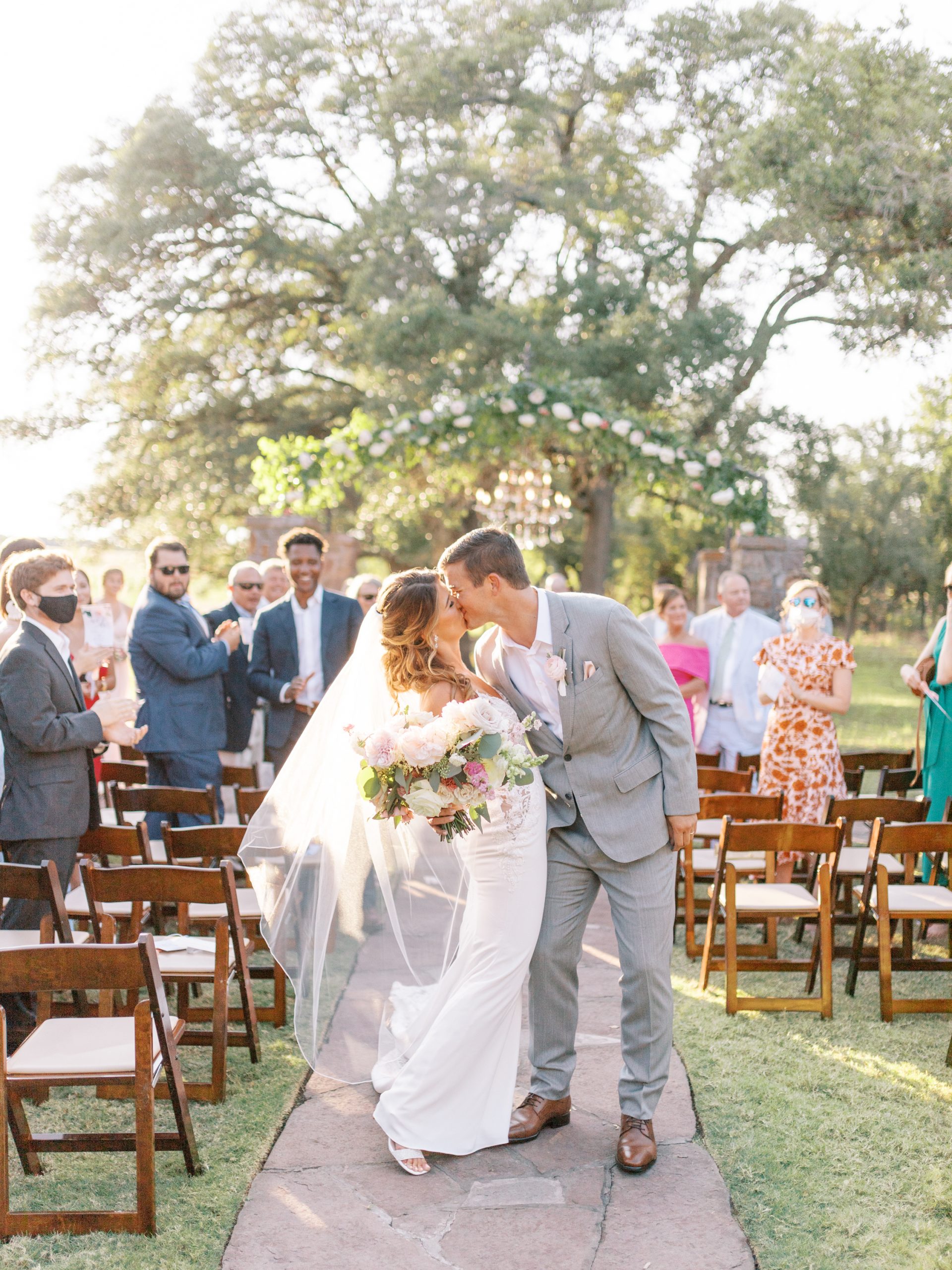 couple walking down the aisle at ma maison wedding venue dripping springs texas