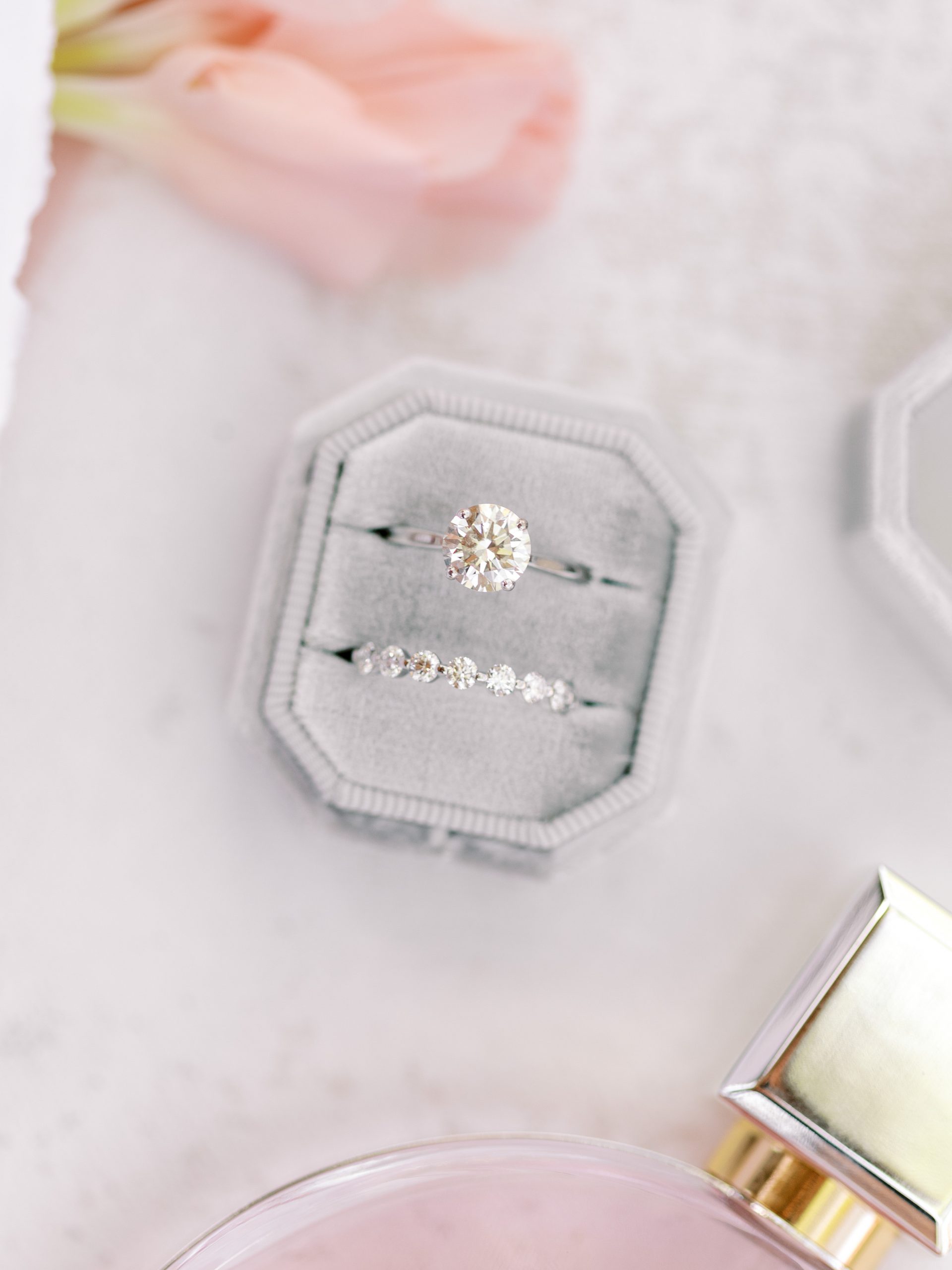 Engagement ring and wedding band in a gray Mrs. Box at Firefly Farm Wimberley Texas wedding venues